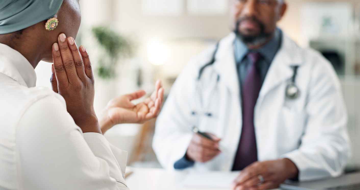 Patient describing teeth and jaw pain to medical professional.